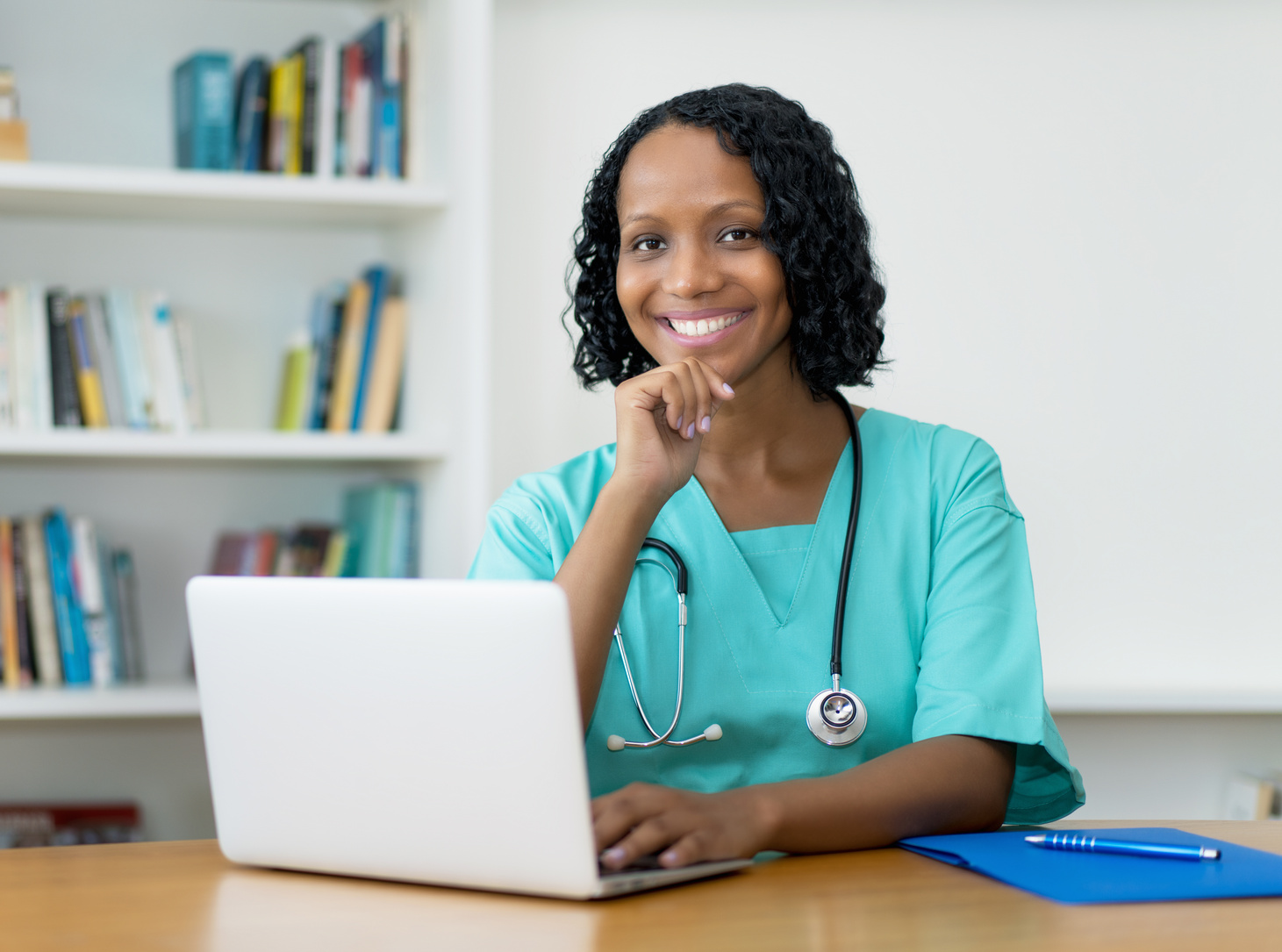Pretty african american doctor at computer