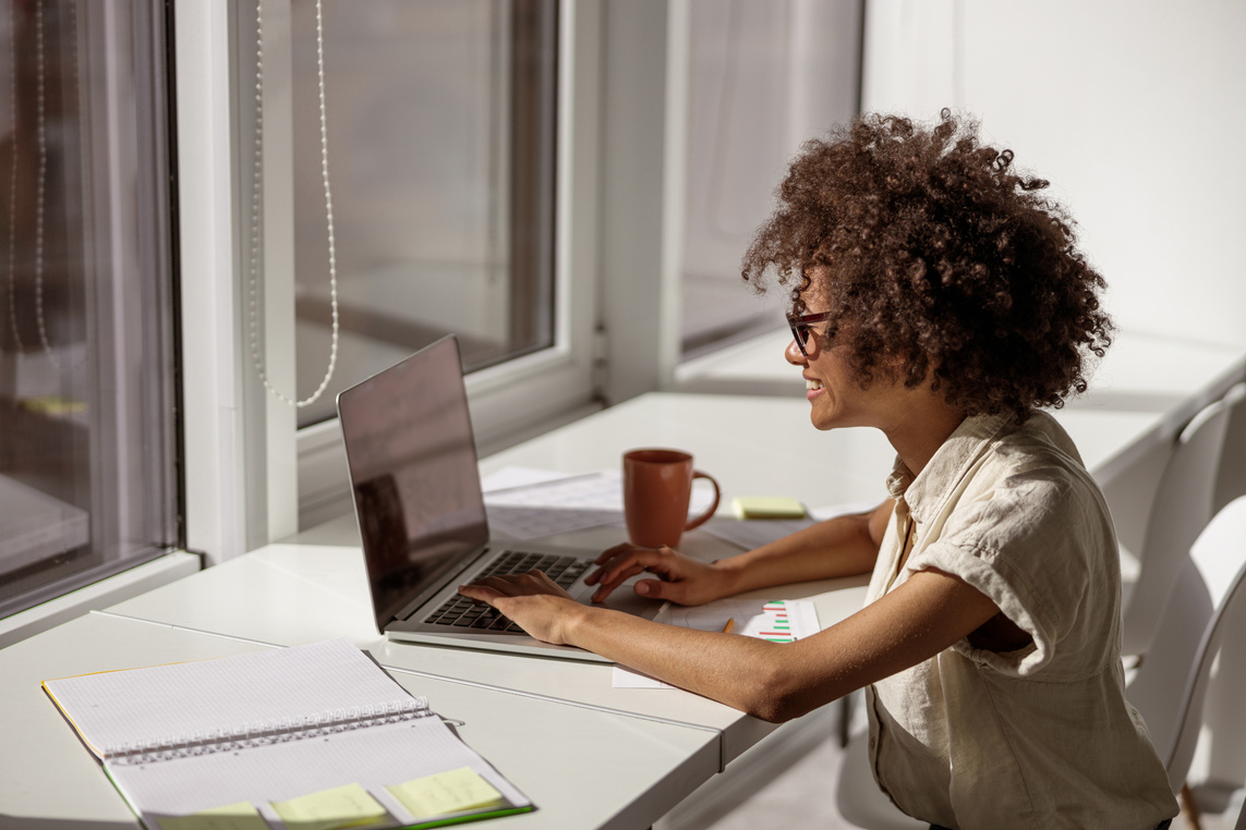 African American Woman Concentrated Looking at Computer Screen